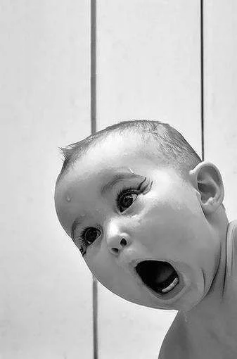 Baby has a funny shocked expression.webp