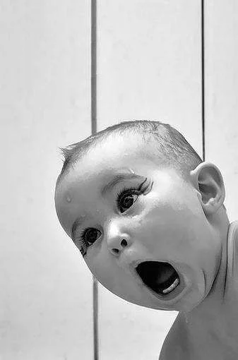 Baby has a funny shocked expression.webp