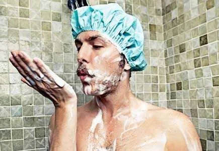 man in shower with cap on_web size.webp