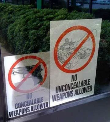 no-weapons-funny-sign.webp