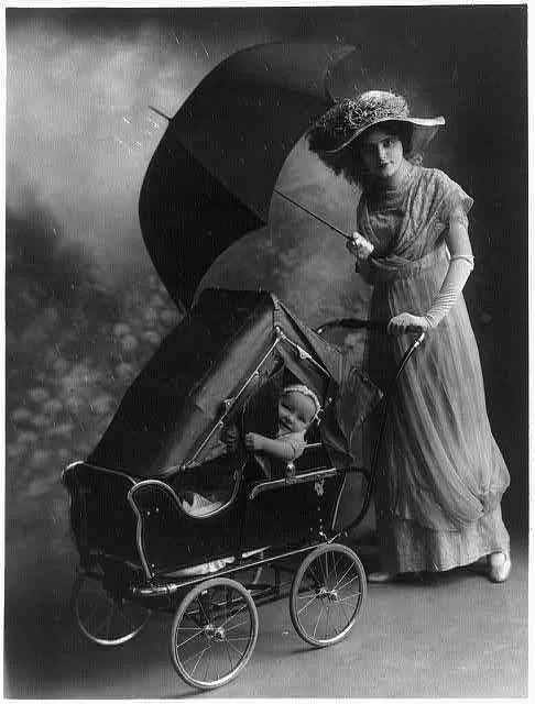 [Woman,-holding-umbrella,-pushing-baby-in-carriage-equipped-with-rain...-painting-artwork-print.webp